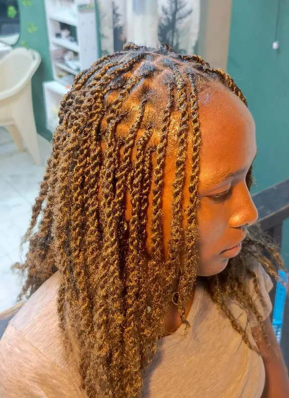Golden brown twists finished with loose curly ends, supplied by NBD